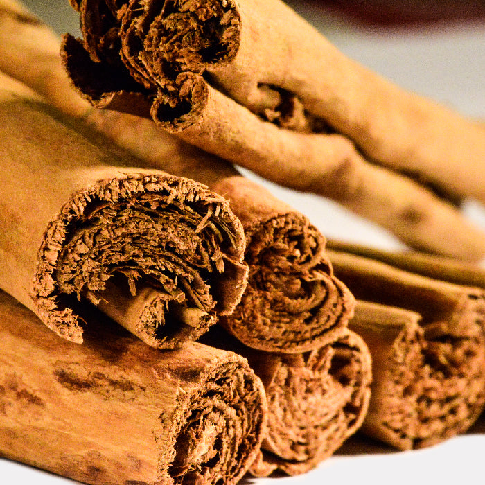 A close-up of Cinnamon Sticks Ceylon by Whole Spice Inc., stacked together to reveal the spice’s detailed texture and rolled layers, perfect for adding aromatic flavor to your baking.
