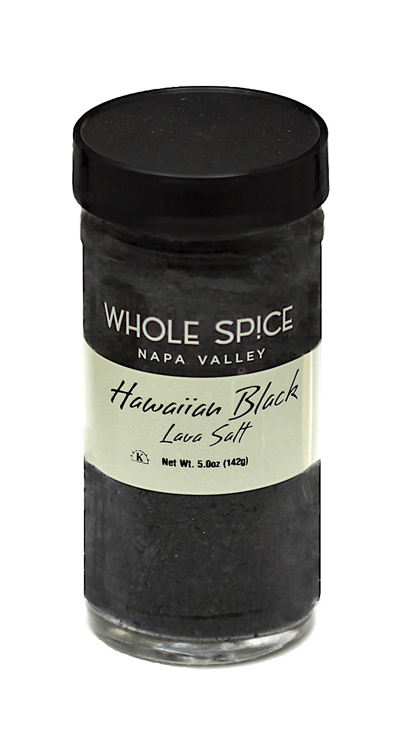 A glass jar with a black lid labeled Whole Spice Inc. Hawaiian Black Lava Salt, Net Wt. 5.0oz (142g), contains coarse sea salt infused with activated charcoal for a bold finish.