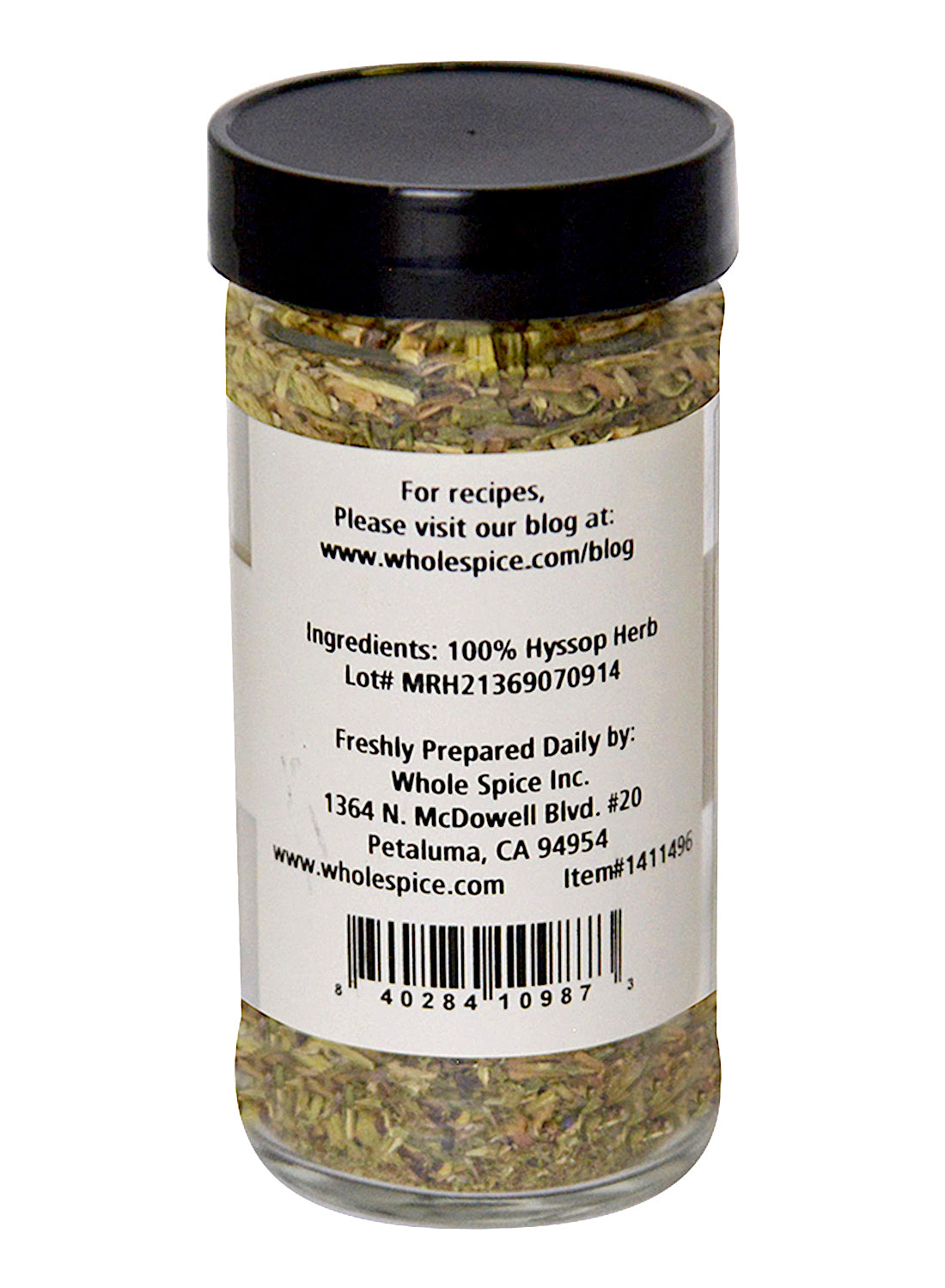A clear spice jar with a black lid holds Whole Spice Inc. Hyssop Herb—100% hyssop, ideal for tea. The label includes contact info for Whole Spice Inc., Petaluma, California.