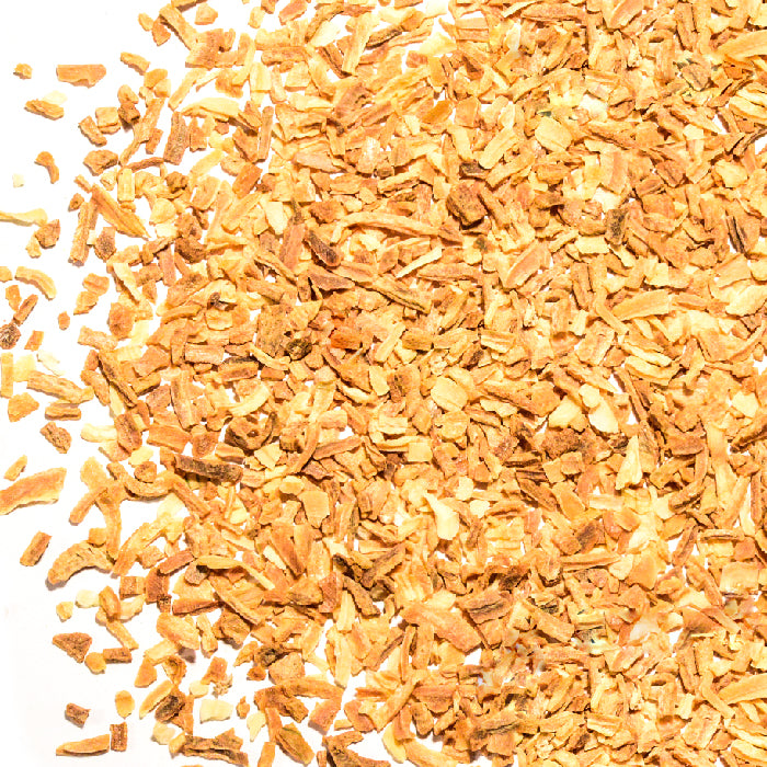 Whole Spice Inc. Onion Toasted Flakes are golden-brown, rough-textured dehydrated flakes scattered on a white background—ideal for enhancing soup bases and your favorite recipes.