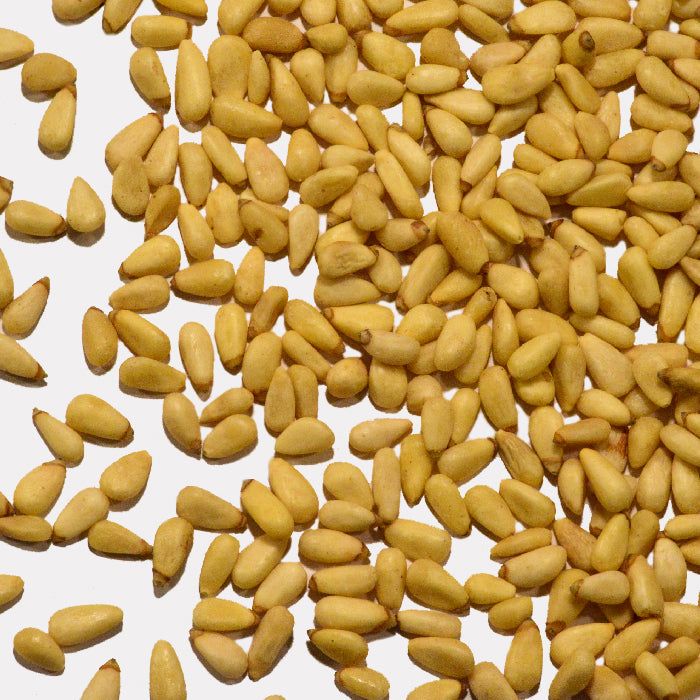 Whole Spice Inc. Raw Pine Nuts are displayed on a white background, ideal for making fresh pesto sauce.
