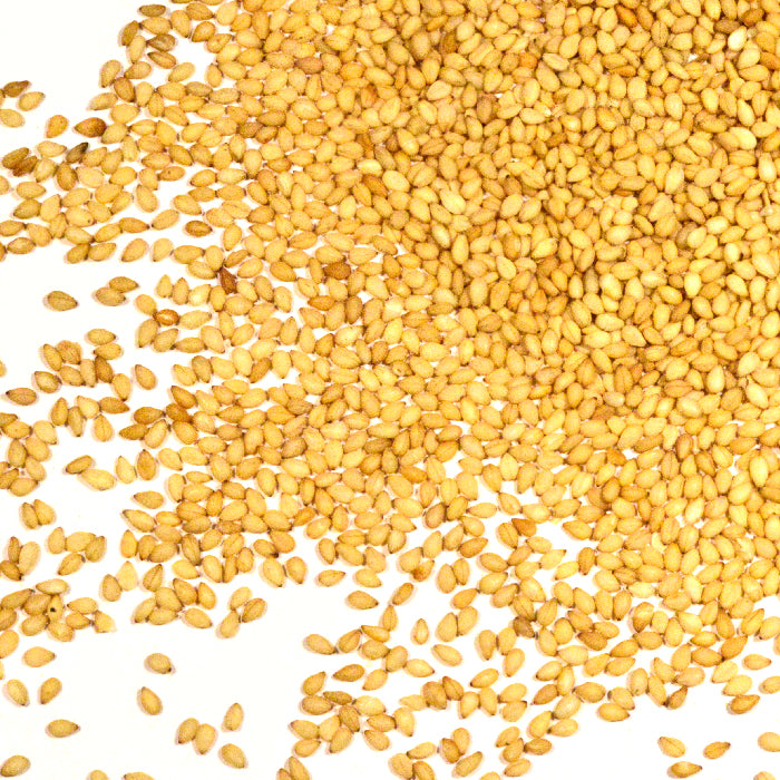 A scattered pile of Whole Spice Inc. Sesame Seeds Natural Toasted on a white background, with seeds unevenly spread out.