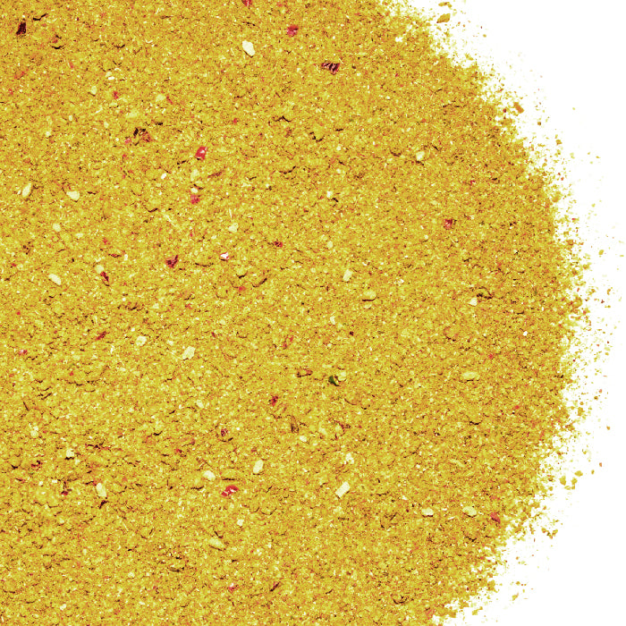 A close-up of Whole Spice Inc. Soup Base Seasoning shows yellow granules with red and white spice specks, arranged in a circular shape on a white background.