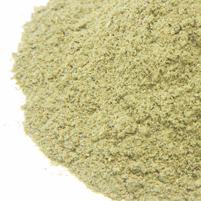 A close-up of Stevia Herb Ground by Whole Spice Inc. shows a fine, slightly textured powder spread on a white surface.
