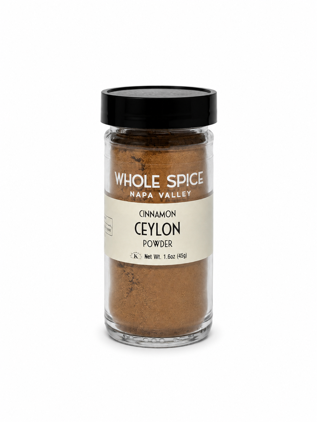 A clear glass jar with a black lid labeled Whole Spice Inc. Cinnamon Powder Ceylon contains 1.6 oz (45g) of finely ground Ceylon cinnamon, renowned for its delicate flavor and natural anti-inflammatory qualities—ideal for baking or enhancing your favorite dishes with a healthful touch, all presented against a white background.