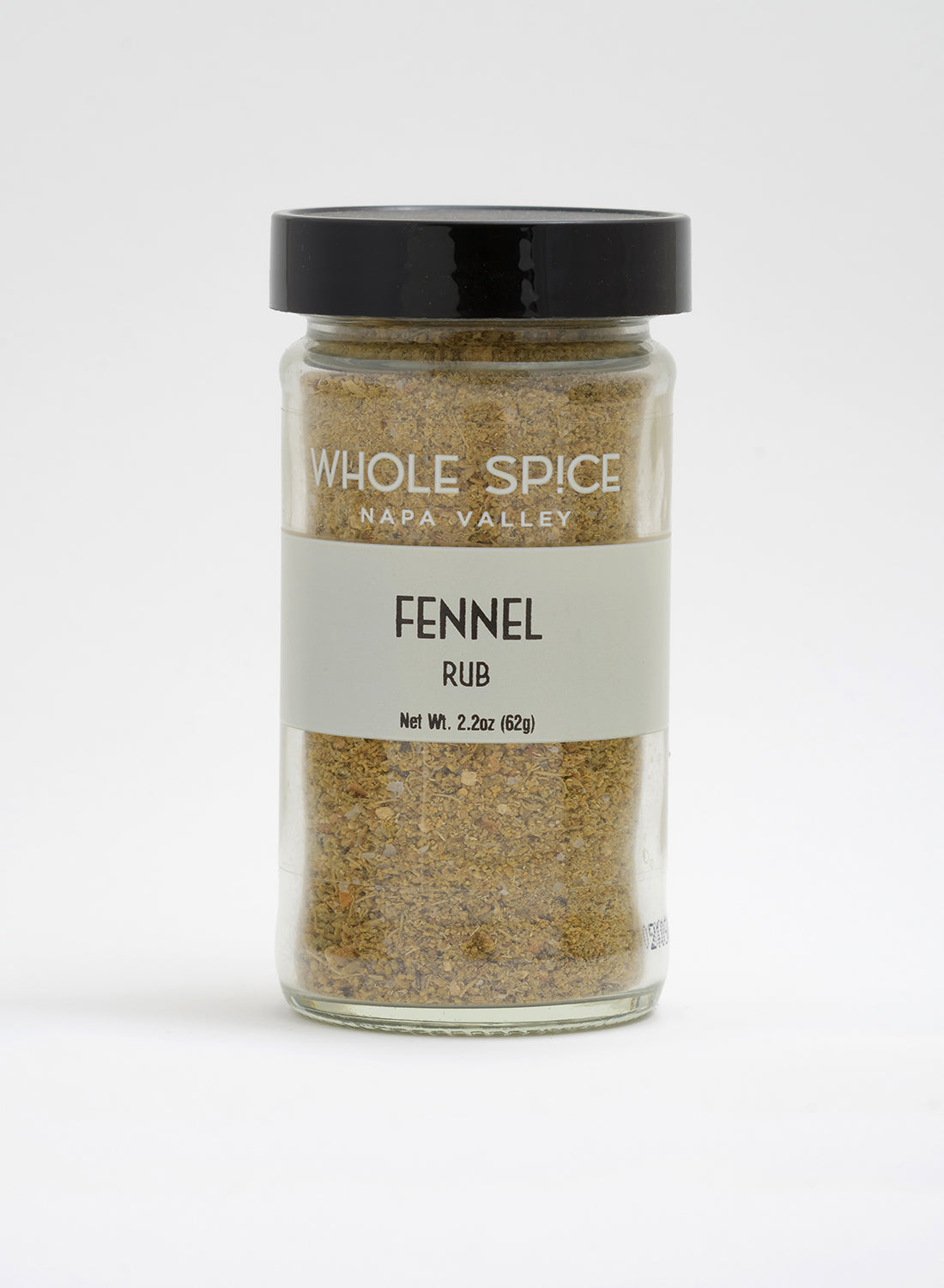 A glass jar with a black lid of Whole Spice Inc. Fennel Rub (net weight 2.2oz/62g), perfect for seasoning roasted fish or adding fennel pollen flavor, set against a plain white background.