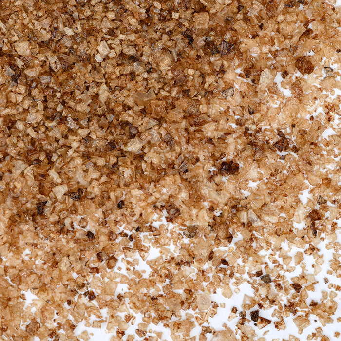 Hickory Smoked Sea Salt Fine by Whole Spice Inc. delivers rich, wood-grilled aromas and deep, smoked hickory flavor in every brown crystal.