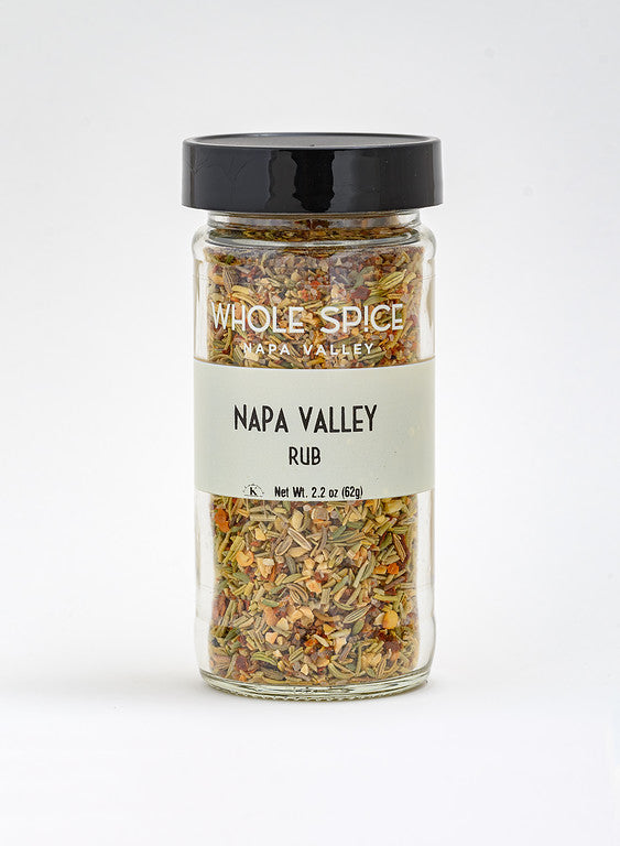 A 2.2 oz (62g) clear glass jar with a black lid from Whole Spice Inc., labeled Napa Valley Rub, contains a flavorful blend of dried herbs and spices—perfect for a versatile marinade. Pictured against a plain white background.