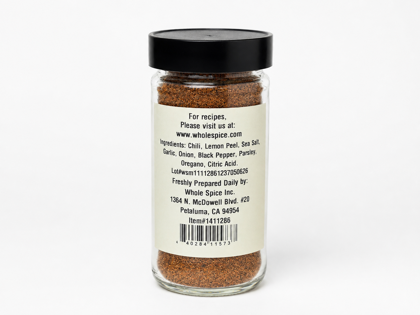 A glass spice jar labeled “Peri Peri Blend” from Whole Spice Inc., featuring a black lid and an ingredient list that includes chili, African birds-eye pepper, lemon peel, and sea salt—ideal for bringing authentic Peri Peri seasoning to your spicy marinades.