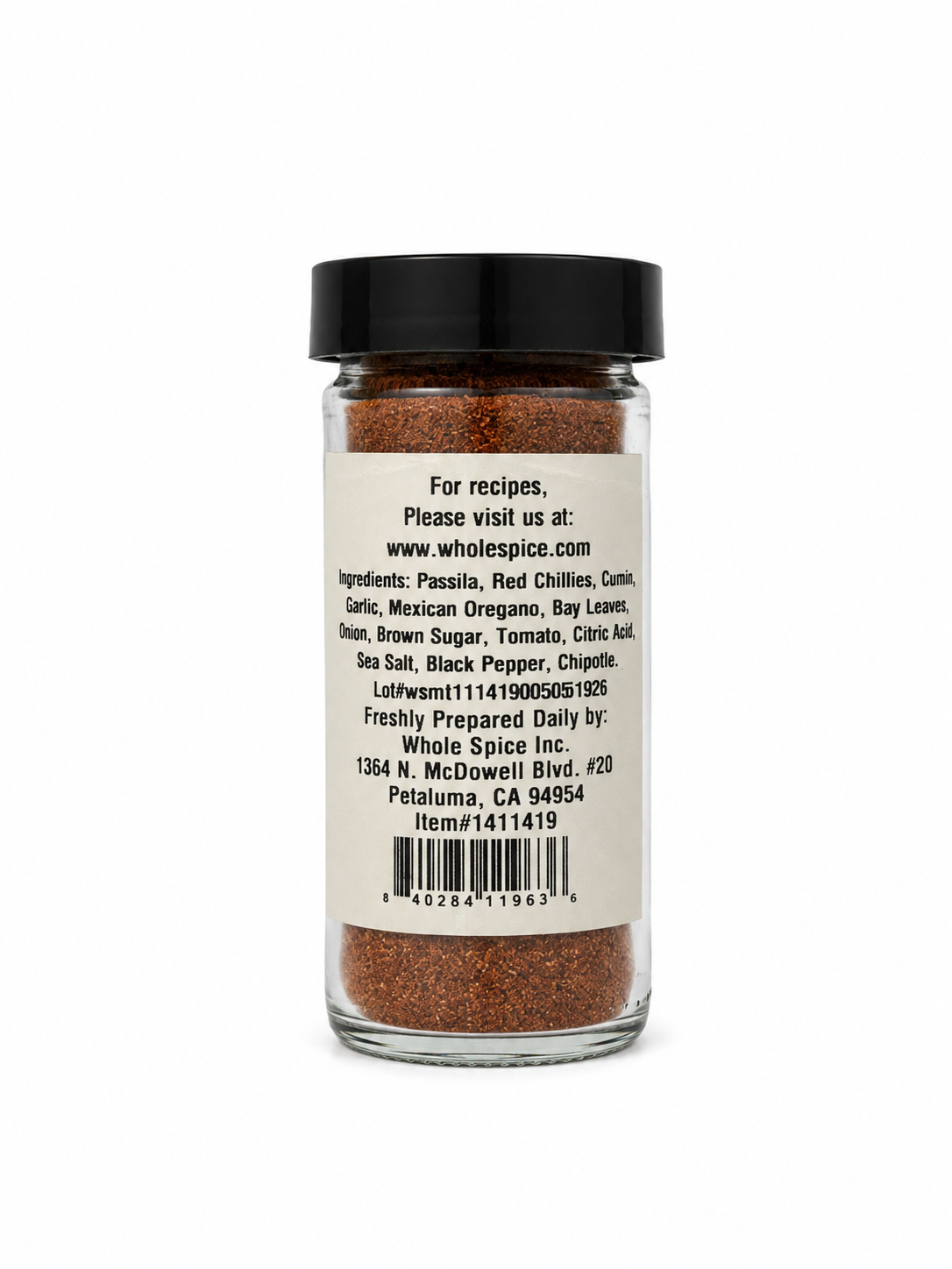 A glass spice jar labeled “Taco Seasoning” from Whole Spice Inc. features a white label listing ingredients such as chili, cumin, and garlic along with the company address and website—ideal for bringing authentic Mexican flavor to your dishes as a classic taco seasoning or an all-purpose Mexican seasoning blend.