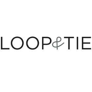 The image shows the Loop & Tie logo with the words LOOP and TIE in black uppercase letters and an ampersand (&) in gray between them. The background is white.