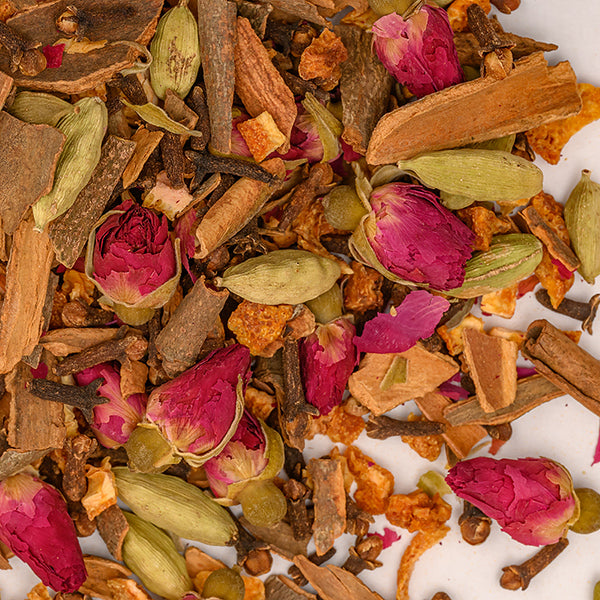 A close-up of Whole Spice Inc.’s Havdalah Mix displays whole spices—rosebuds, green cardamom pods, cinnamon bark, cloves, and orange peel—used in the Jewish Sabbath ceremony on a white background.
