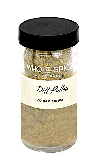 A clear glass jar with a black lid contains Dill Pollen by Whole Spice Inc., a unique seasoning ideal for fish. The label shows "Whole Spice Dill Pollen," net weight 1 oz (28g).