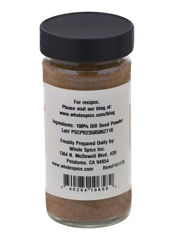 A clear spice jar with a black lid displays a back label listing ingredient, barcode, and company info. It contains 100% Dill Seed Powder from Whole Spice Inc., Petaluma, CA—valued in Scandinavian cuisine for aiding digestion.