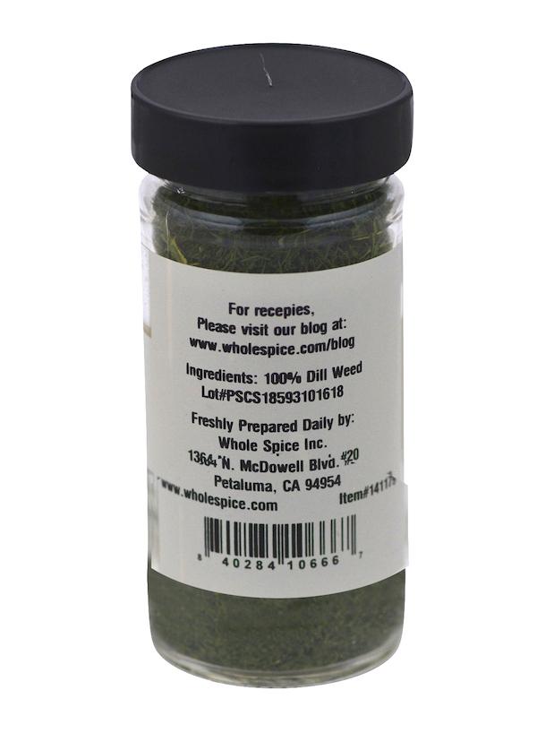 A clear spice jar from Whole Spice Inc. with a black lid, labeled "Dill Weed" (100% Mediterranean herb). The label displays ingredients, barcode, company contact info, and a recipe link.