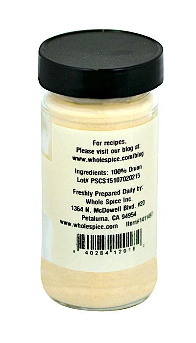 A clear glass jar with a black lid holds Onion Toasted Powder by Whole Spice Inc., made from 100% dehydrated onion—ideal as a soup base. The label features the brand’s contact info and a website for recipes.