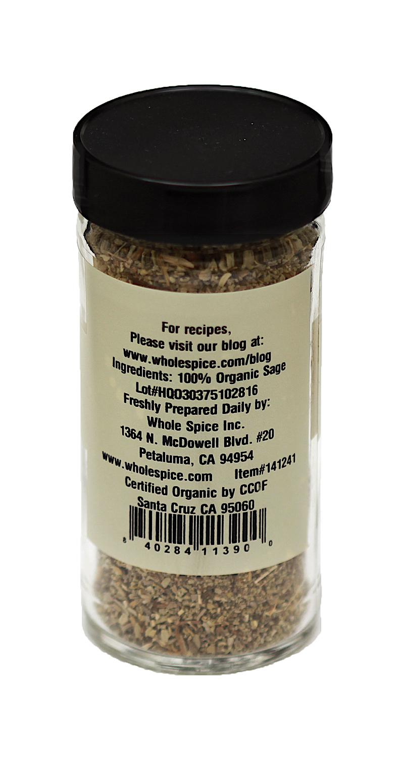 A glass jar of Whole Spice Inc. Sage Crushed Organic with a black lid, showing the back label listing 100% organic sage, ideal for poultry seasoning, plus company info, website, and a barcode at the bottom.
