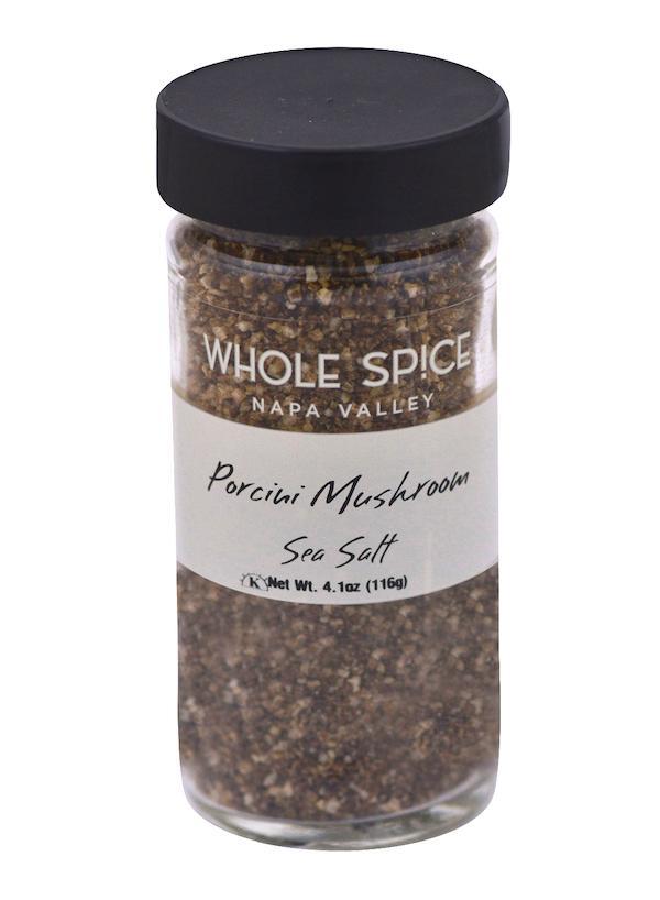A glass jar with a black lid contains Whole Spice Inc. Porcini Mushroom Sea Salt, a flavorful finishing salt with rich mushroom notes. The label lists the net weight as 4.1 oz (116 g).
