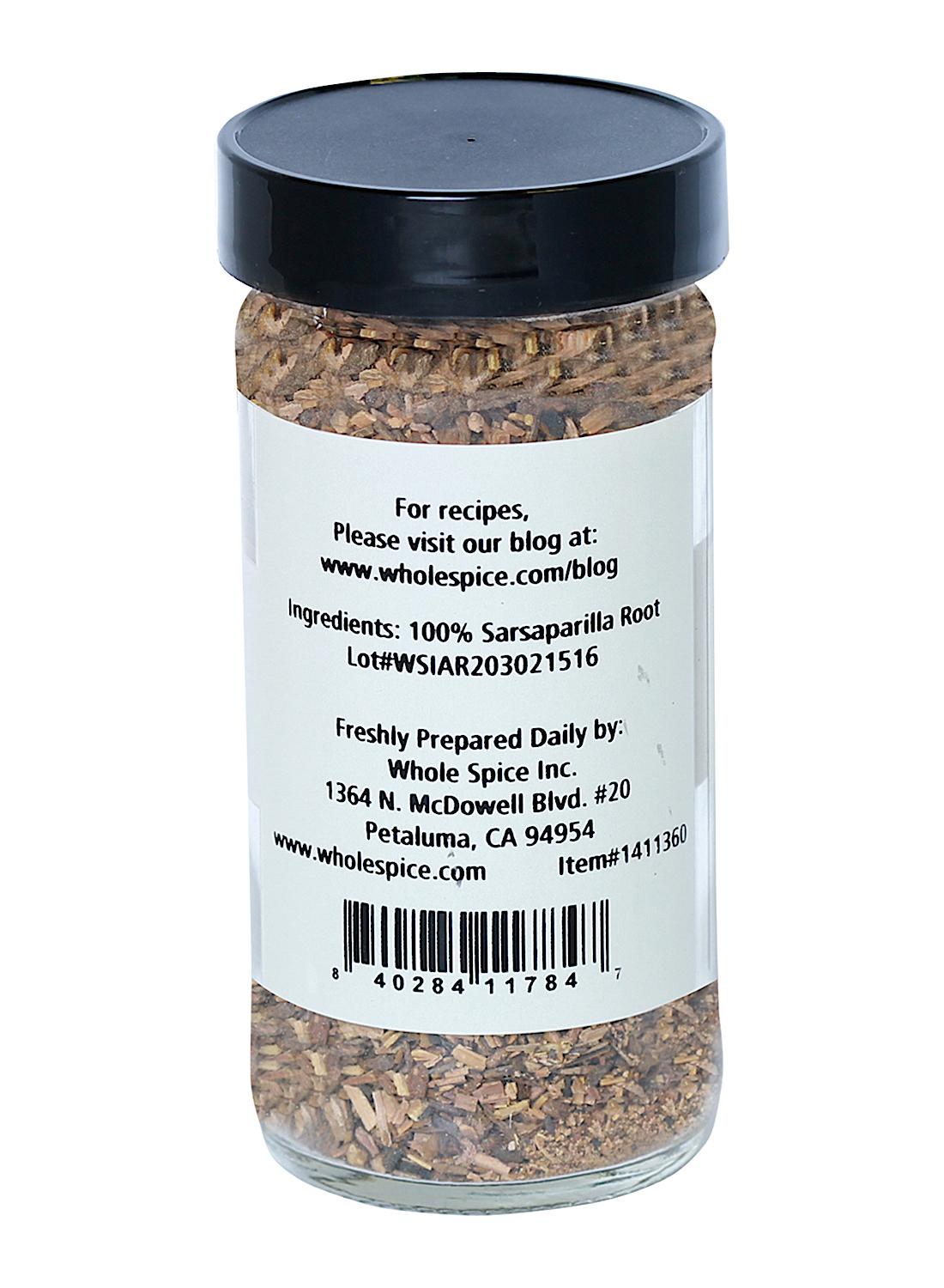 A clear jar with a black lid, labeled "Sarsaparilla Root Cut" (100% Smilax Ornata) by Whole Spice Inc., includes product info, website, and company address in Petaluma, CA.