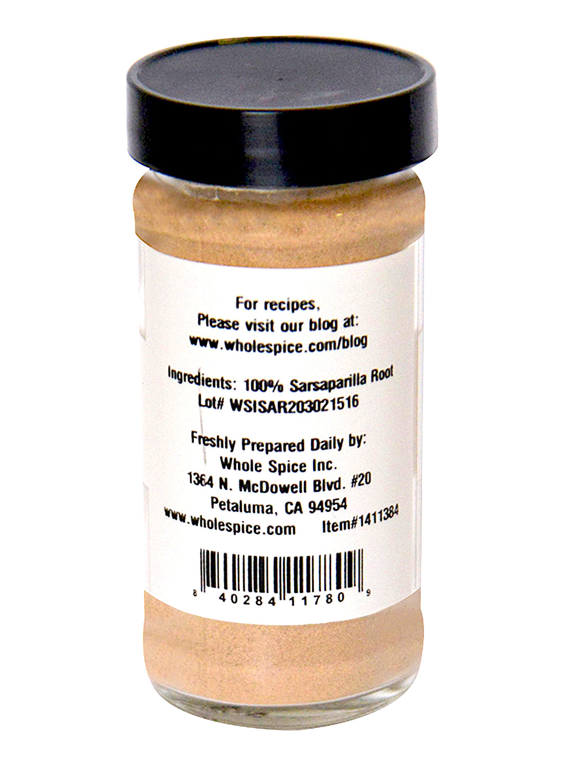 A clear spice jar from Whole Spice Inc., labeled Sarsaparilla Root Powder (Hemidesmus Indicus), has a black lid, contact info, barcode, and a website link for recipes featuring this versatile dried herb.