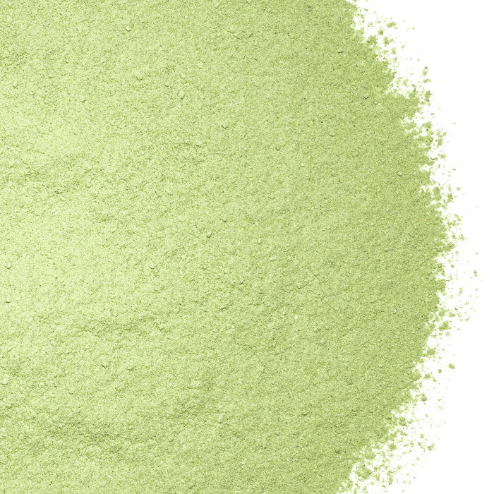 A close-up of Whole Spice Inc. Spinach Powder highlights its vibrant green color and fine texture.